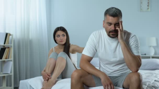 Man suffering problems with masculine health, wife supporting him, impotence - Video, Çekim