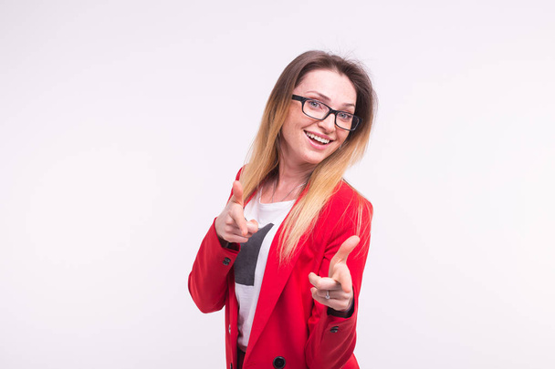Pointing stylish business lady in red fashionable suit and glasses on white background. - Photo, Image