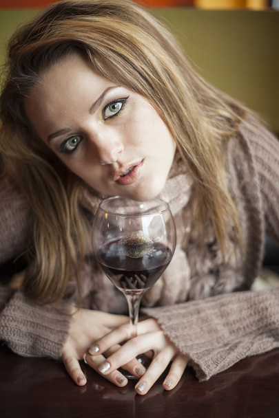 Young Woman with Beautiful Blue Eyes Drinking Red Wine - Fotoğraf, Görsel