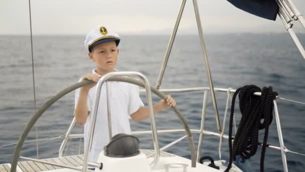 Litle skipper bambini al timone controlli di uno yacht a vela durante la gara
. - Filmati, video