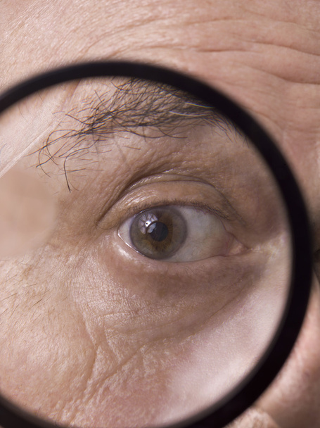an eye on the magnifying glass - Photo, Image