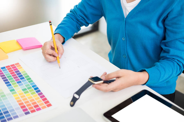 interior design or graphic designer renovation and technology concept - woman working with colour samples for selection. at workplace choosing colour swatches, closeup. Creative people  - Photo, Image