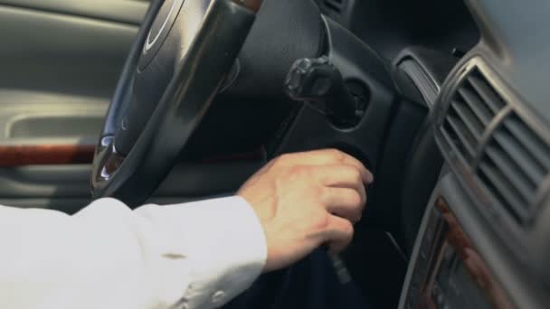 Man starting car, shifting gear, chauffeur driving for client, taxi service - Materiaali, video