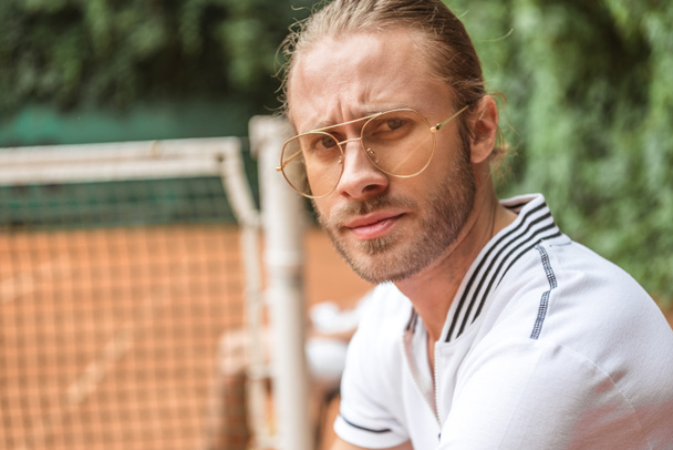 portrait of handsome tennis player in eyeglasses - Photo, Image