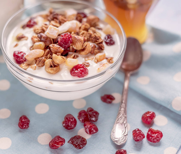 Homemade yoghurt, granola, cereal grains, honey in jars on a gentle blue background. Healthy healthy food. - Foto, Imagen