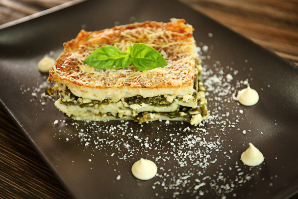 Lasagna with spinach on plate, close up - Photo, image