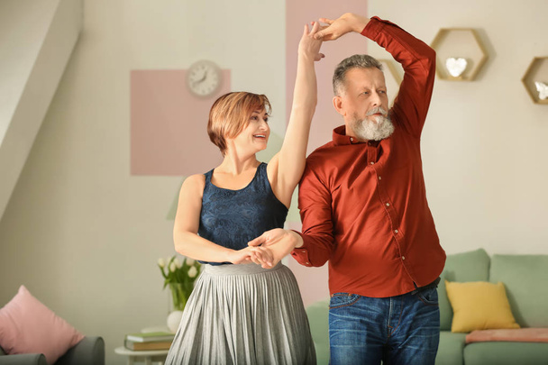 Happy mature couple dancing at home - Фото, зображення