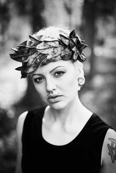 black and white photo of gorgeous young woman in elegant headdress posing outdoors  - Photo, Image