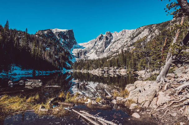 Dream Lake and reflection with mountains in snow around at autumn. Rocky Mountain National Park in Colorado, USA.  - 写真・画像