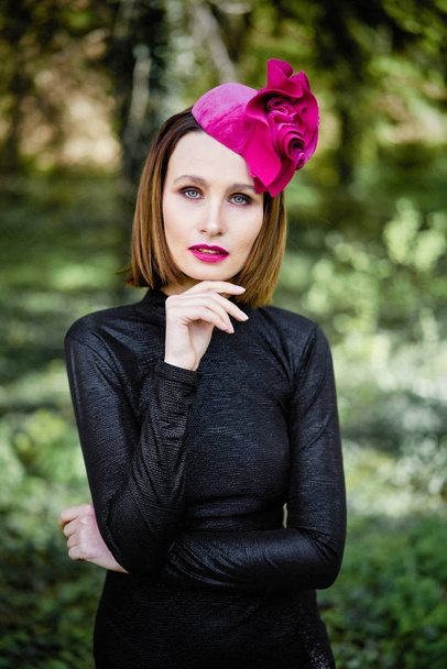 gorgeous young woman in elegant headdress posing outdoors  - Fotó, kép