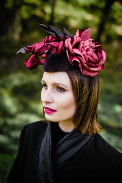 gorgeous young woman in elegant headdress posing outdoors  - Foto, Imagem