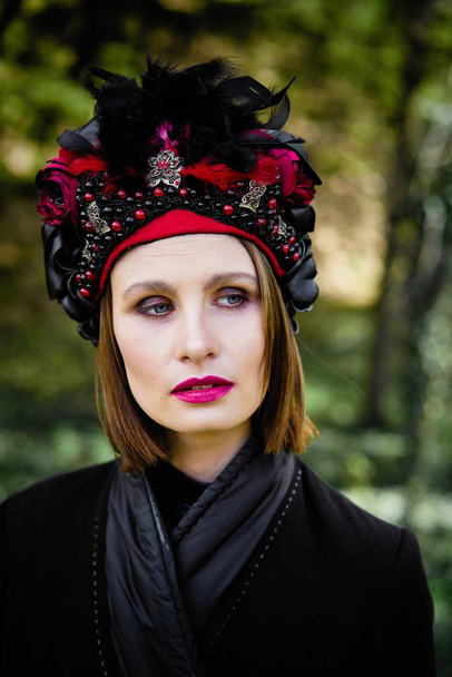 gorgeous young woman in elegant headdress posing outdoors  - Fotografie, Obrázek