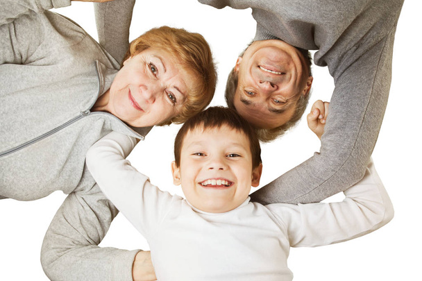 Grandmother with grandfather and grandson hugging in a circle. concept-happy family - Фото, изображение