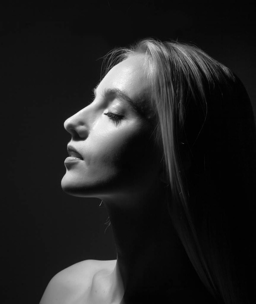 Portrait of a beautiful blonde on a black background. - Fotoğraf, Görsel