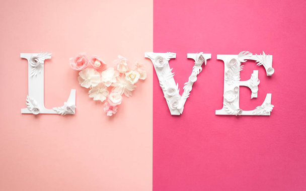Photo inscription love made of leaves and flowers on pink background. lettering. Design elements for Valentine's day. - Foto, immagini