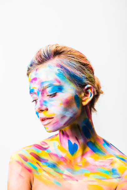 beautiful woman with colorful bright body art looking down isolated on white  - Valokuva, kuva