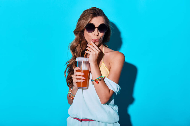 gorgeous brunette young woman drinking cocktail in studio  - Fotó, kép