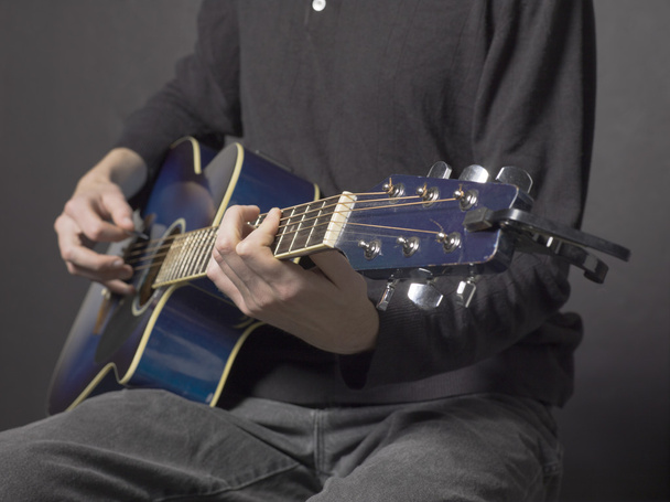 a man strumming acoustic guitar - Foto, Imagen