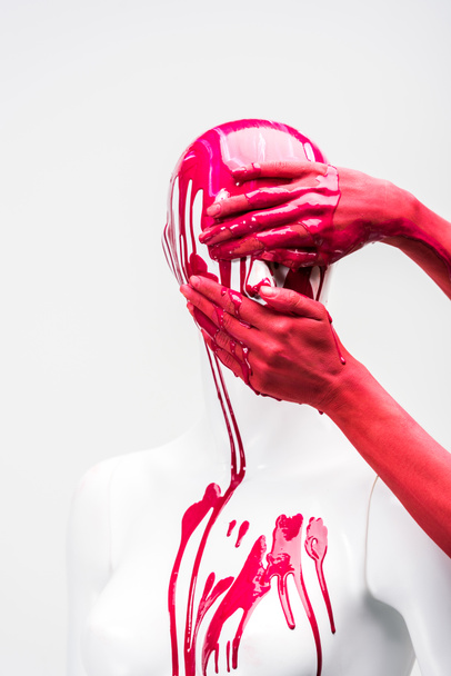cropped image of woman in red paint covering mannequin face isolated on white - Foto, Imagem