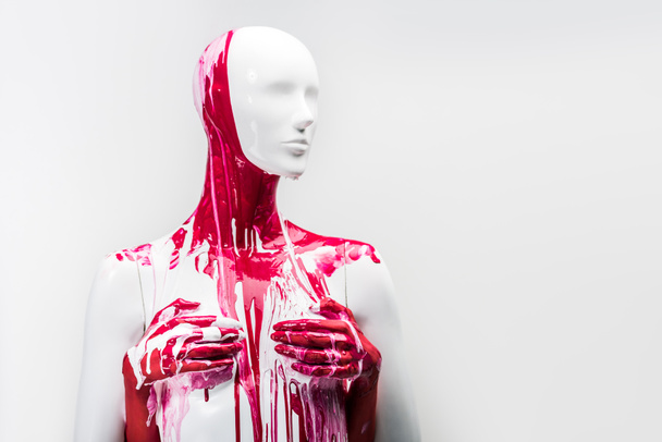 cropped image of woman in red paint touching mannequin breasts isolated on white - Foto, imagen