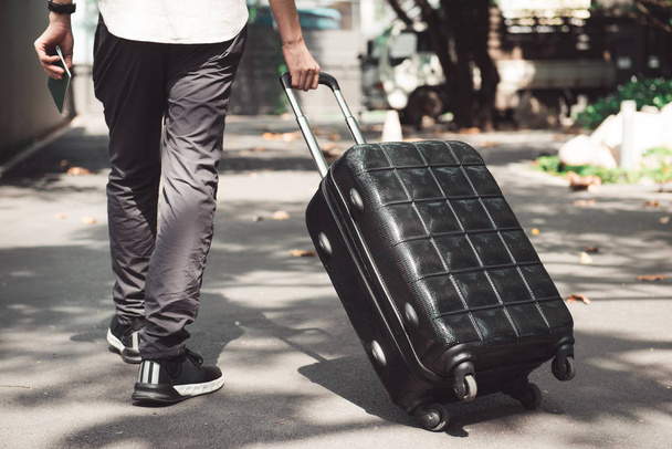 Young man and traveling luggage suitcase walking - Photo, Image