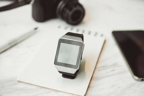 Unknown smart wrist watch laying on the table - Photo, Image