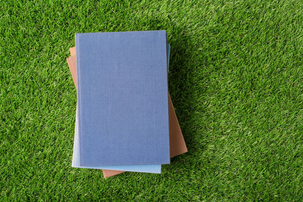 Old  book on green grass. Top of view - Fotoğraf, Görsel