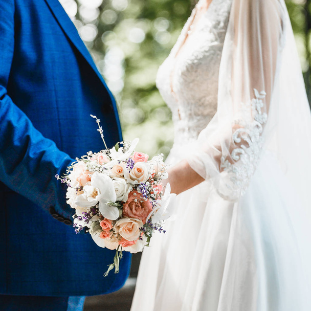 close-up of a bride's bouquet in the hands of a loving couple - Zdjęcie, obraz