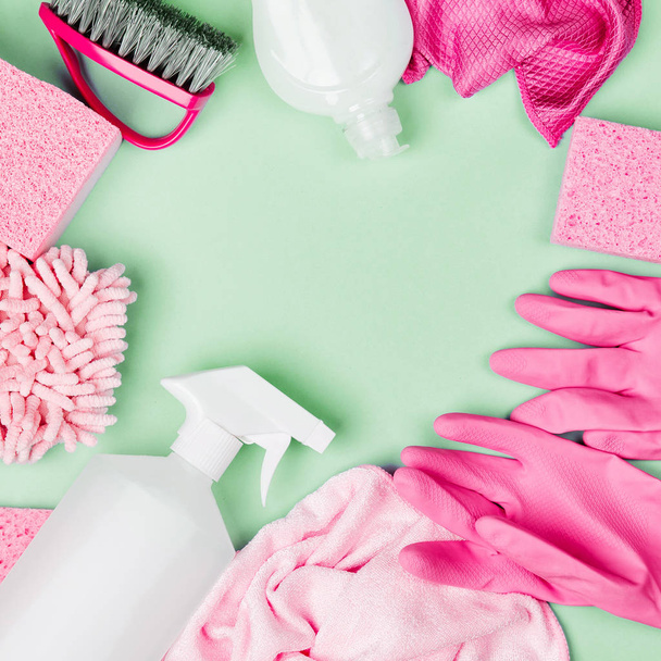 Detergents and cleaning accessories  in pink color.  Cleaning service concept. Flat lay, Top view. - Photo, image