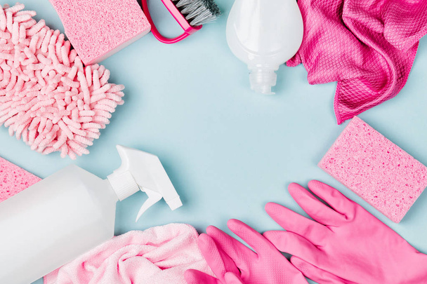 Detergents and cleaning accessories  in pink color.  Cleaning service concept. Flat lay, Top view. - Fotoğraf, Görsel