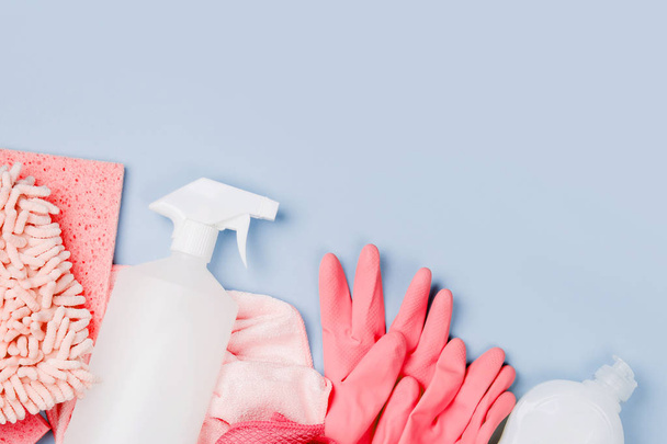 Detergents and cleaning accessories  in pink color.  Cleaning service concept. Flat lay, Top view. - Fotoğraf, Görsel
