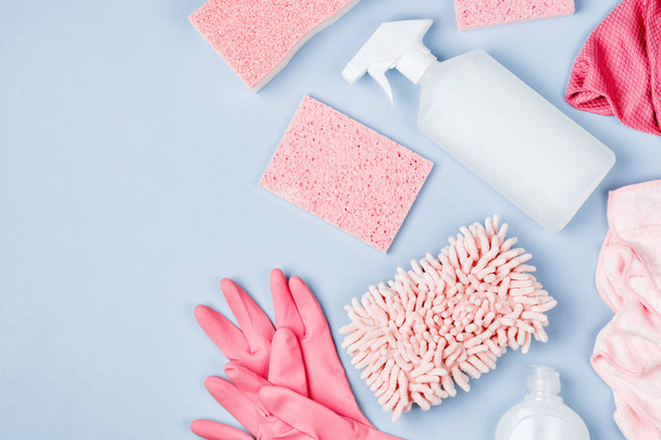 Detergents and cleaning accessories  in pink color.  Cleaning service concept. Flat lay, Top view. - Foto, imagen