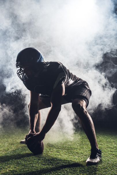 silhouette of athletic american football player in star position against white smoke - Photo, Image