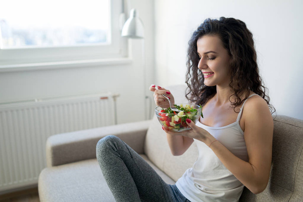 Fitness young woman eating healthy food after workout - Fotografie, Obrázek