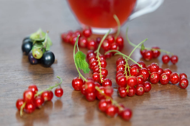 Summer berries.Red and Black Curratnts.Red Juice Glass on Wooden table. Food Concept.  - Fotografie, Obrázek