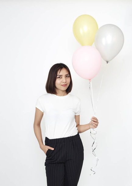 Attractive young asian woman with air balloons on white background - Zdjęcie, obraz