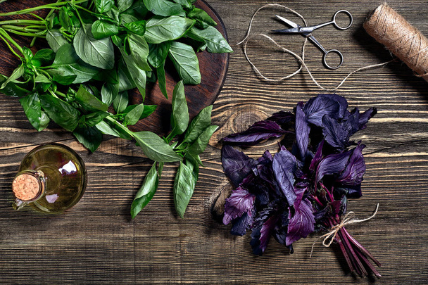 Green and purple fresh basil on wooden background. Top view - Fotó, kép