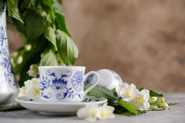 Still life with a tea set and jasmine flowers. - Фото, зображення