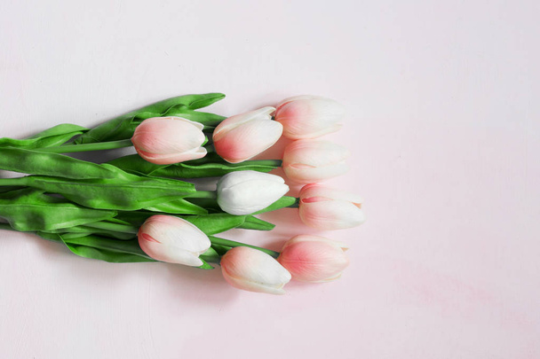 Bouquet of pink tulips on a light wooden painted background. Copy space made for greeting cards. Concept Mothers day. - Fotografie, Obrázek