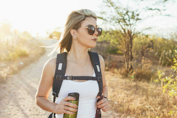 Happy young woman hiking with backpack - Photo, Image