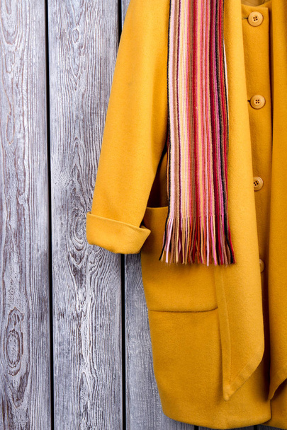 Close up yellow coat sleeve and scarf. - Photo, Image