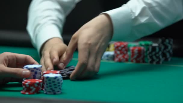 Professional croupier shuffling and dealing cards, strategy, gambling fortune - Filmati, video