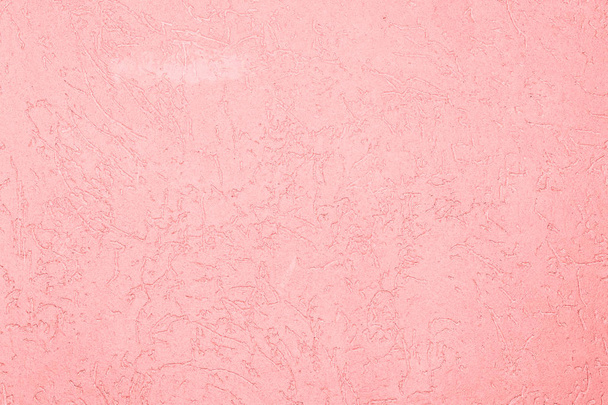 the pink texture of the surface of the wall covered with decorative plaster of the woodworm type, close-up architecture abstract background - Photo, image