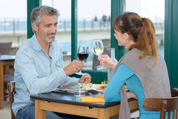 Man and lady toasting with wine glasses - Φωτογραφία, εικόνα