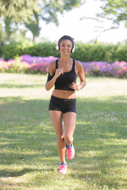 beautiful sporty woman jogging outdoor - Photo, image