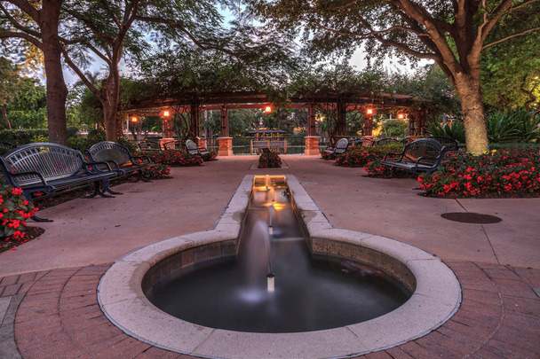 Nighttime fountain and entryway of the Garden of Hope and Courage memorial garden and sanctuary in Naples, Florida. - Фото, зображення