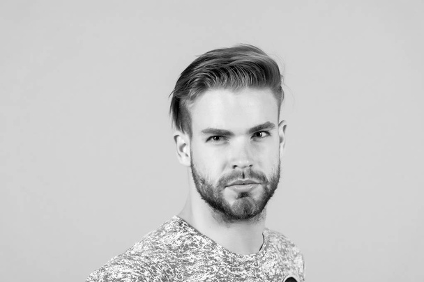 Macho with bearded face, beard. Man with blond hair, haircut. Grooming and hair care in beauty salon, barbershop. Fashion, style and trend concept - Foto, Imagem