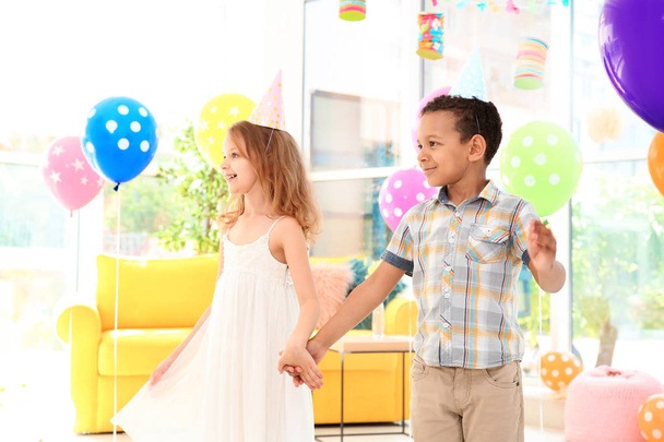 Cute little children at birthday party indoors - 写真・画像