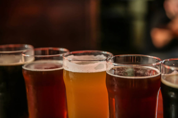 Glasses of different beer on dark background, closeup - Photo, Image