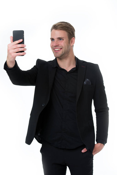 Happy to see you. Business man smartphone video conferencing isolated white. Businessman smiling face video call. Businessman black suit take advantages of video conferencing. Streaming video online - Фото, изображение